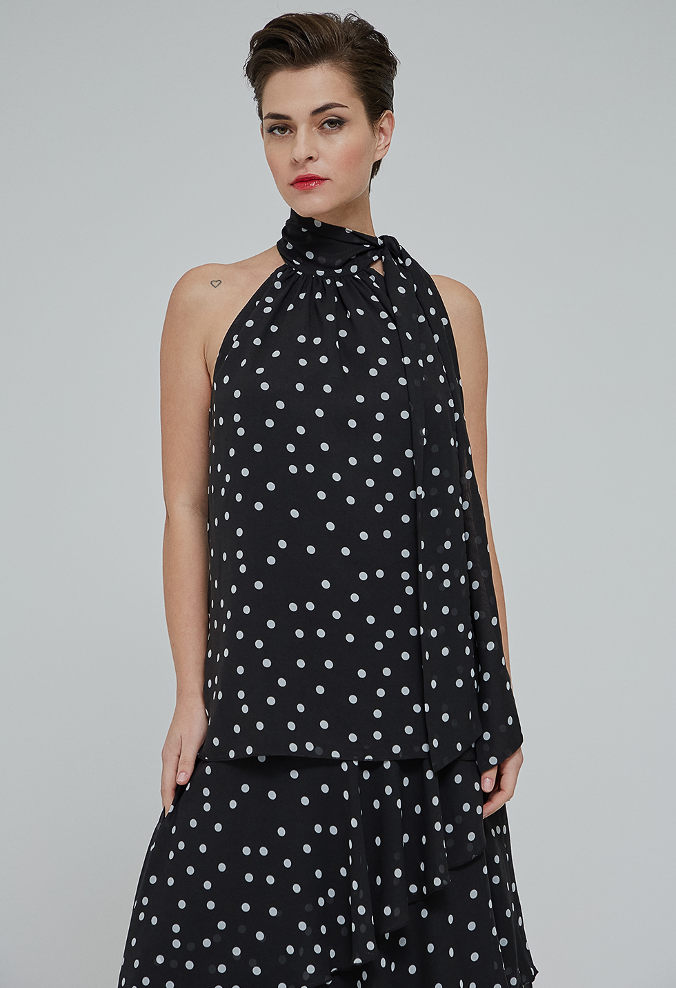 Polka dot blouse with tie-neck.