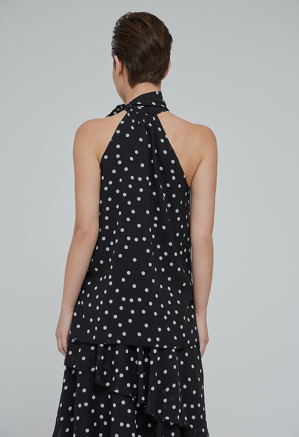 Polka dot blouse with tie-neck.