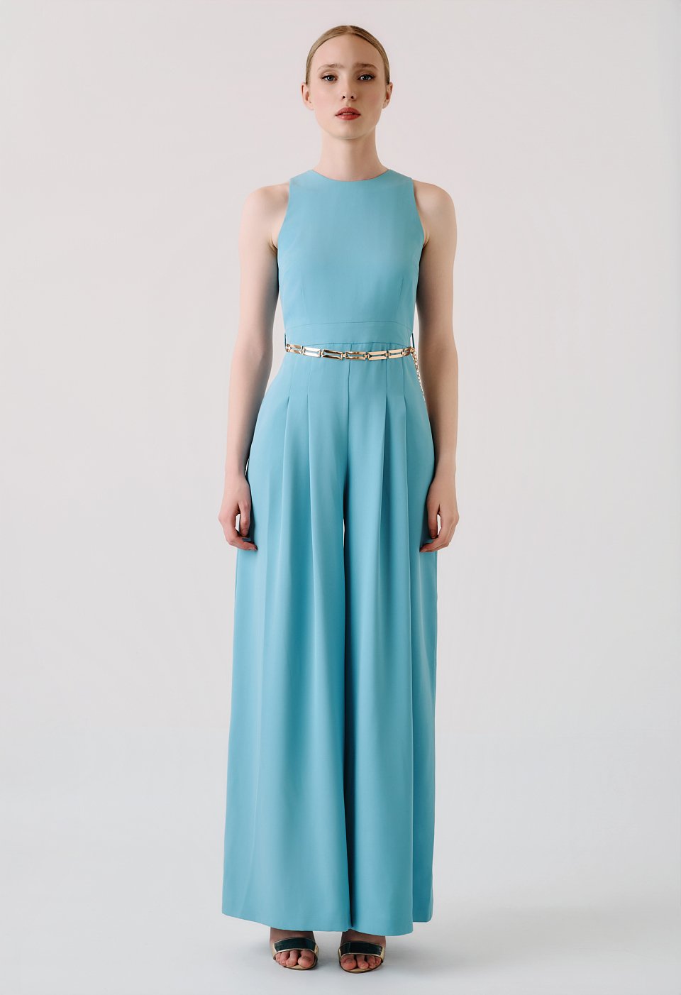 Light blue wide-leg jumpsuit with pleats and gold belt