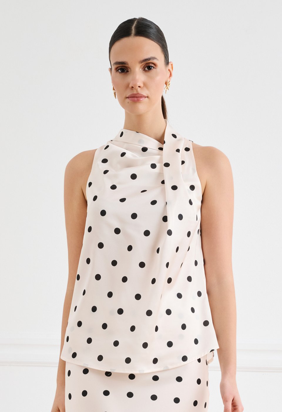 Satin polka-dot blouse with an asymmetrical draped neckline