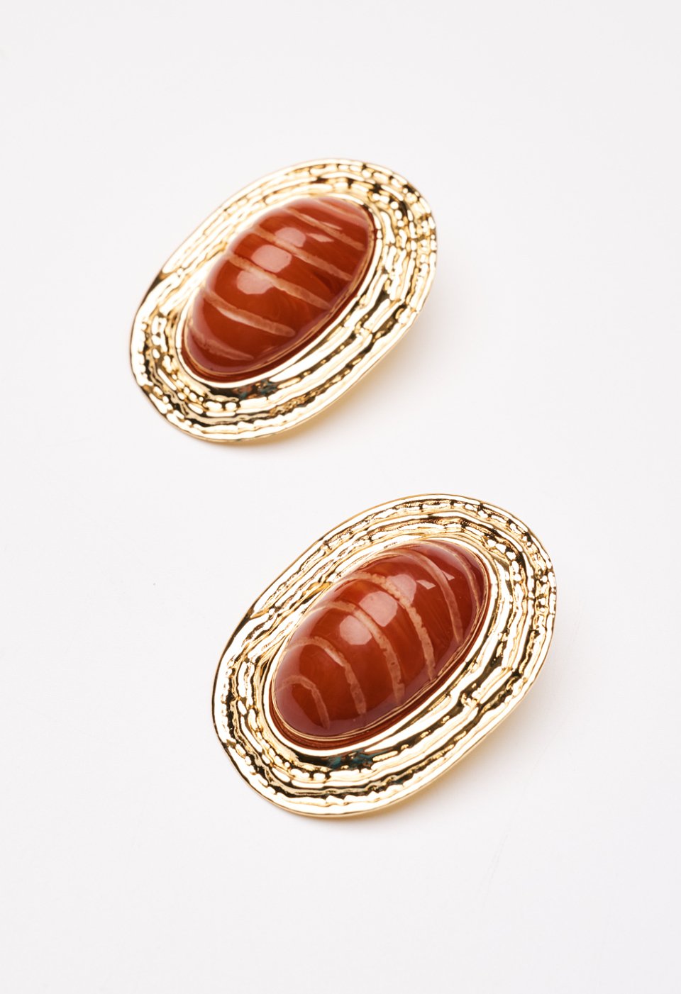 Earrings with textured surface and resin stone