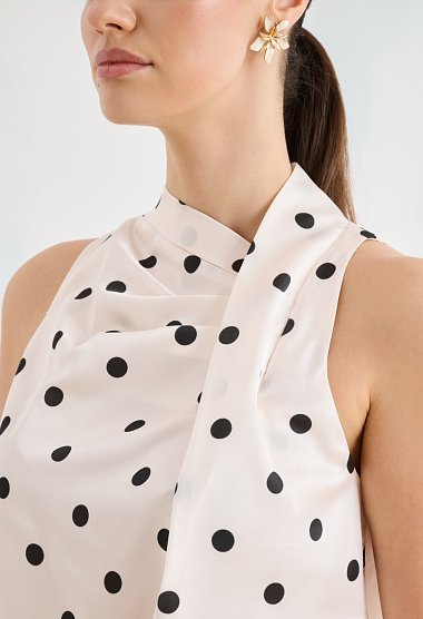 Satin polka-dot blouse with an asymmetrical draped neckline