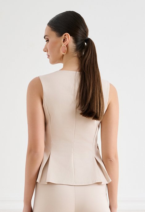 Sleeveless top with peplum and V-neckline
