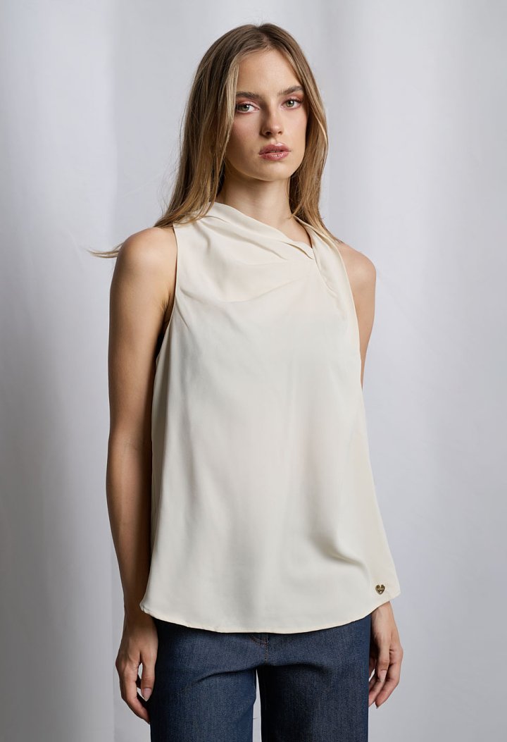 Sleeveless blouse with asymmetric draped neckline