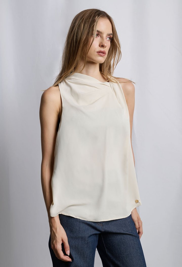 Sleeveless blouse with asymmetric draped neckline