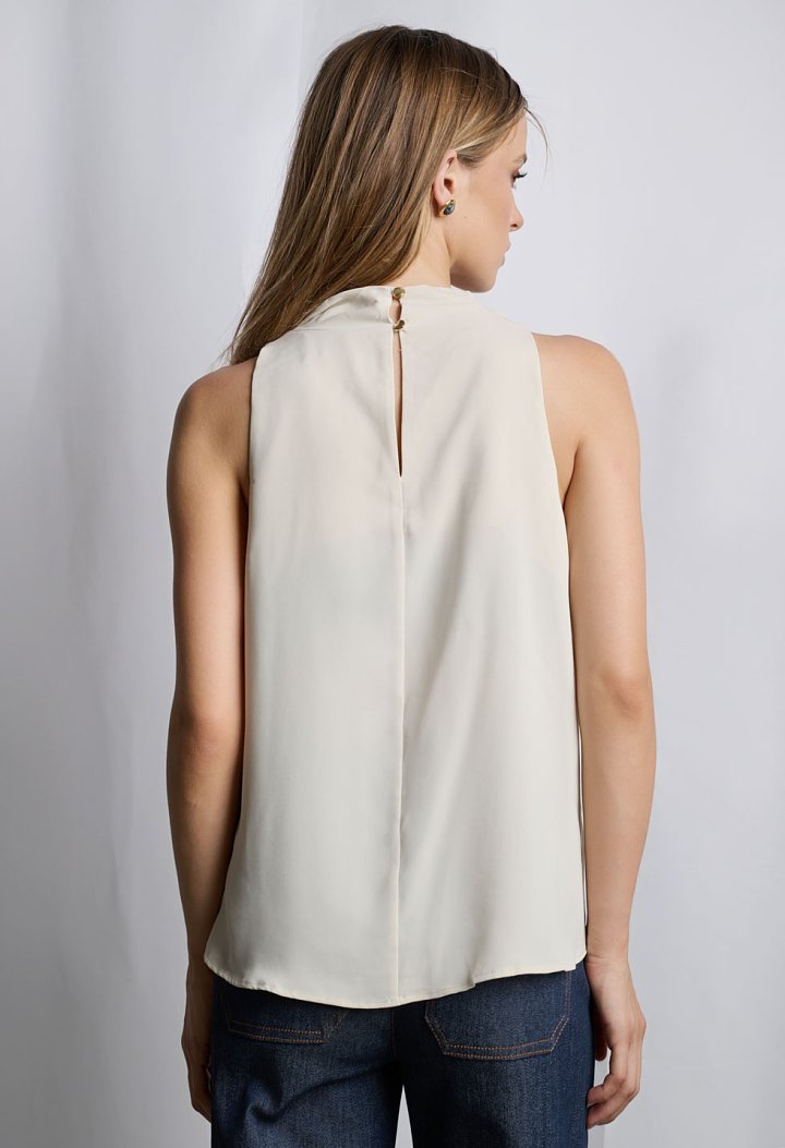 Sleeveless blouse with asymmetric draped neckline