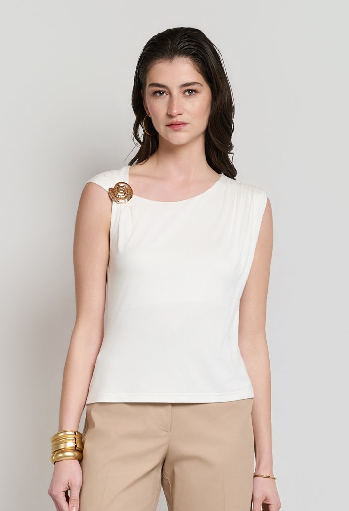 Sleeveless blouse with decorative brooch