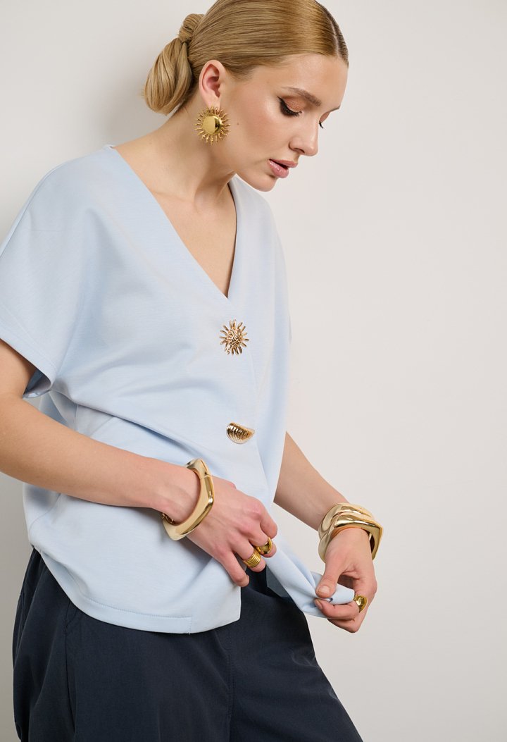 Blouse with a V-neckline and decorative button