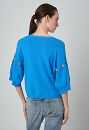 Knitted sweater with embellishment
